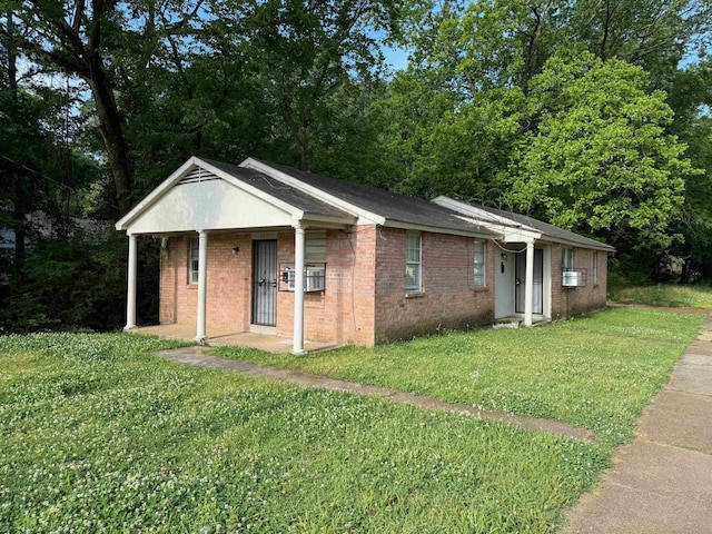 view of front facade with a front lawn and brick siding