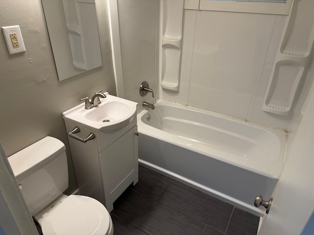 bathroom featuring toilet, vanity, and  shower combination