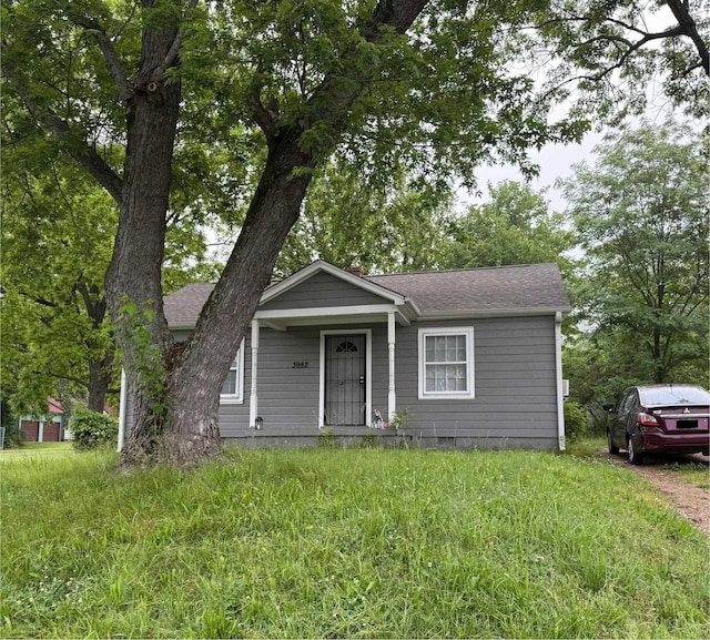 bungalow-style home with roof with shingles and crawl space