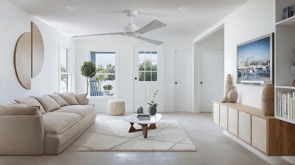 living room featuring ceiling fan and concrete floors