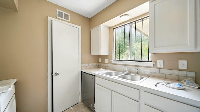 3554 Morning Dew Ct Unit 11, Memphis, TN 38118 - kitchen featuring a sink, dishwashing machine, white cabinets, light countertops, and backsplash
