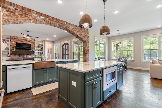 6978 Vaiden Rd, Hernando, MS 38632 - kitchen featuring white dishwasher, open floor plan, a sink, stainless steel microwave, and finished concrete floors
