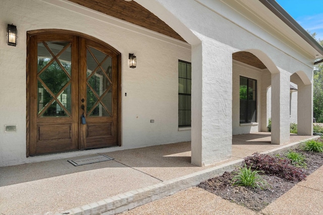 6978 Vaiden Rd, Hernando, MS 38632 - doorway to property featuring stucco siding and a porch