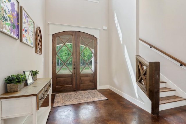 6978 Vaiden Rd, Hernando, MS 38632 - entryway with concrete floors, a towering ceiling, baseboards, and stairway