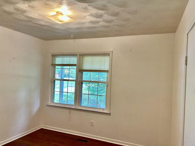 182 Hargett Dr, Ripley, TN 38063 - unfurnished room with baseboards and dark wood-type flooring