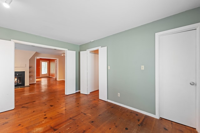 8438 Bergen Dr, Memphis, TN 38018 - unfurnished living room with hardwood / wood-style floors, a lit fireplace, and baseboards