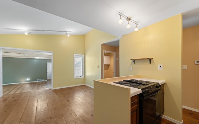 8438 Bergen Dr, Memphis, TN 38018 - kitchen featuring rail lighting, black range with electric cooktop, hardwood / wood-style floors, and baseboards