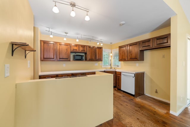 8438 Bergen Dr, Memphis, TN 38018 - kitchen featuring white dishwasher, a sink, a peninsula, dark wood-type flooring, and light countertops