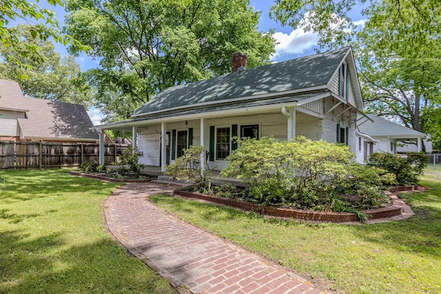 view of front of home featuring a chimney, a porch, and roof with shingles