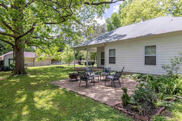 view of yard featuring a fire pit and a patio