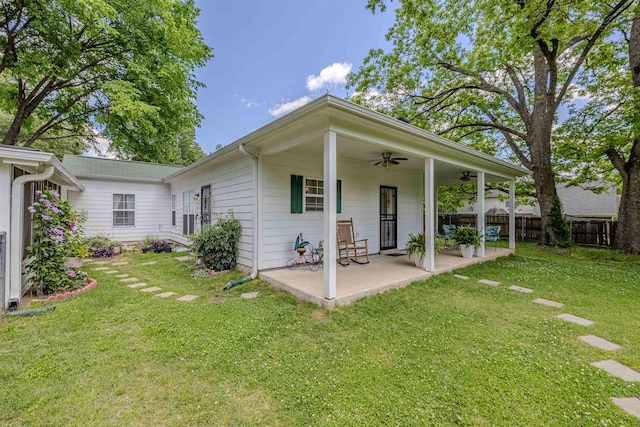 rear view of property with ceiling fan and a patio