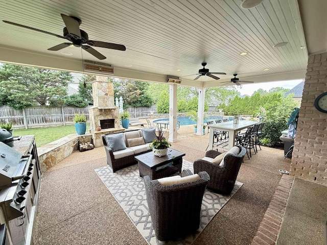 view of patio featuring a fenced backyard, ceiling fan, an outdoor living space with a fireplace, and outdoor dining area