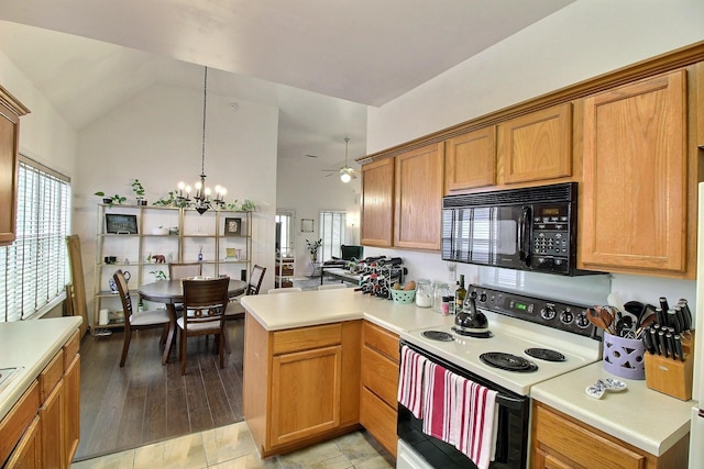 1079 River Isle Dr, Memphis, TN 38103 - kitchen with electric range oven, black microwave, a ceiling fan, light countertops, and high vaulted ceiling