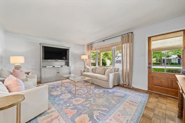 living room featuring crown molding, plenty of natural light, and baseboards