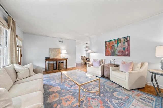 living room featuring ornamental molding and baseboards