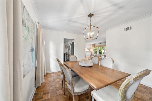dining area featuring crown molding, a chandelier, and baseboards