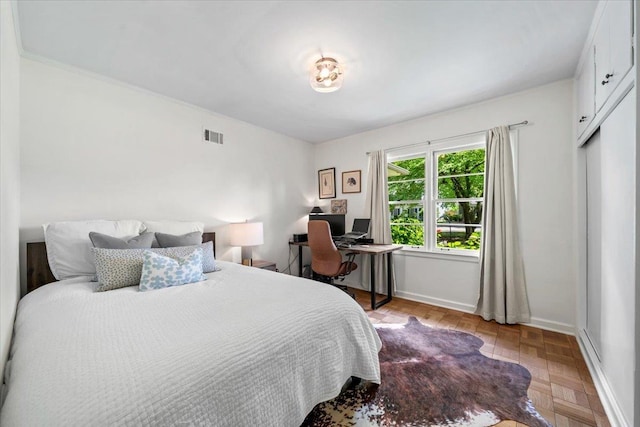 bedroom featuring a desk and baseboards