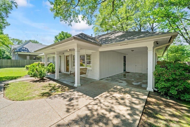view of front facade with brick siding, driveway, and an attached carport