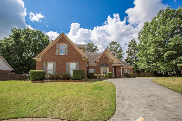 traditional-style home with brick siding and decorative driveway