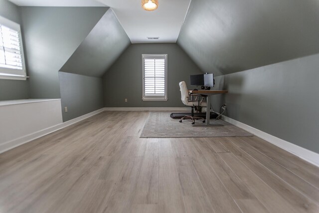 office space with wood finished floors, lofted ceiling, and baseboards