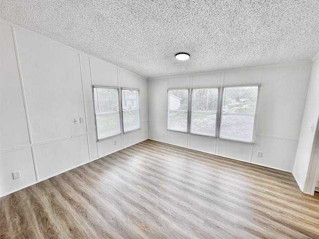 841 Simmons Rd, Munford, TN 38023 - unfurnished living room featuring a textured ceiling, wood finished floors, and vaulted ceiling
