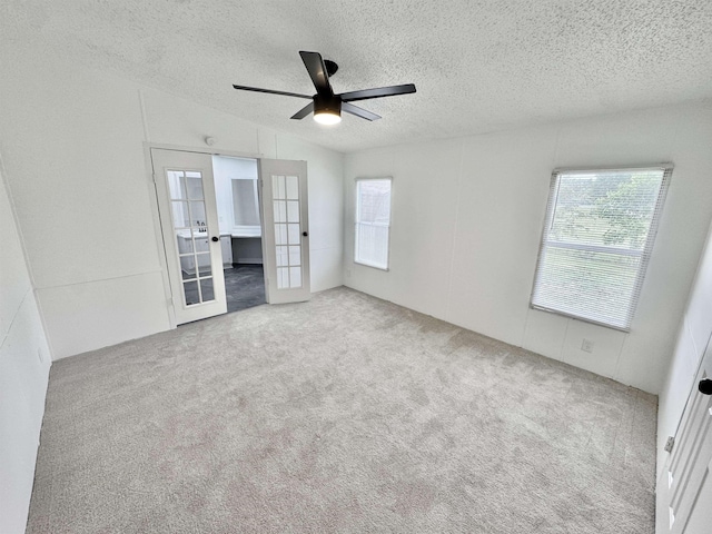 841 Simmons Rd, Munford, TN 38023 - unfurnished bedroom featuring french doors, a textured ceiling, carpet, vaulted ceiling, and connected bathroom