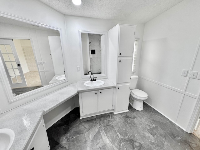 841 Simmons Rd, Munford, TN 38023 - bathroom with a textured ceiling, toilet, vanity, and baseboards