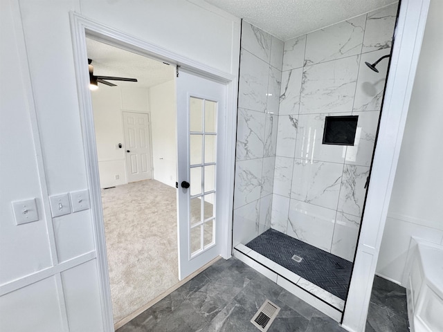 841 Simmons Rd, Munford, TN 38023 - bathroom featuring a tile shower, a textured ceiling, marble look tile flooring, and a ceiling fan