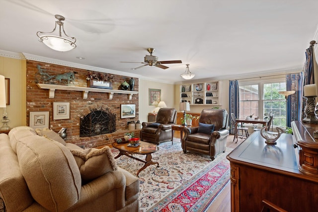 living room with wood finished floors, a ceiling fan, a brick fireplace, and ornamental molding