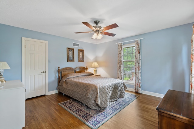 bedroom with wood finished floors, baseboards, and a ceiling fan