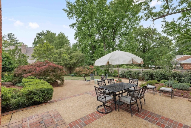 view of patio featuring outdoor dining area and fence