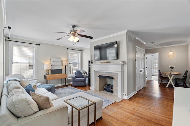 3686 Charleswood Ave, Memphis, TN 38122 - living area featuring a fireplace, wood finished floors, crown molding, ceiling fan, and baseboards