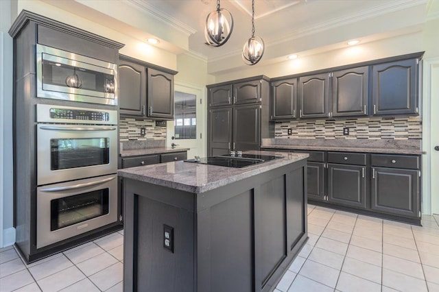 10336 Hatcher Patch Cv, Collierville, TN 38017 - kitchen featuring stainless steel appliances, light tile patterned floors, decorative backsplash, a kitchen island, and ornamental molding