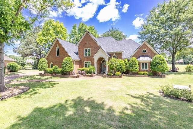 10336 Hatcher Patch Cv, Collierville, TN 38017 - traditional-style home featuring a front lawn, brick siding, and a shingled roof