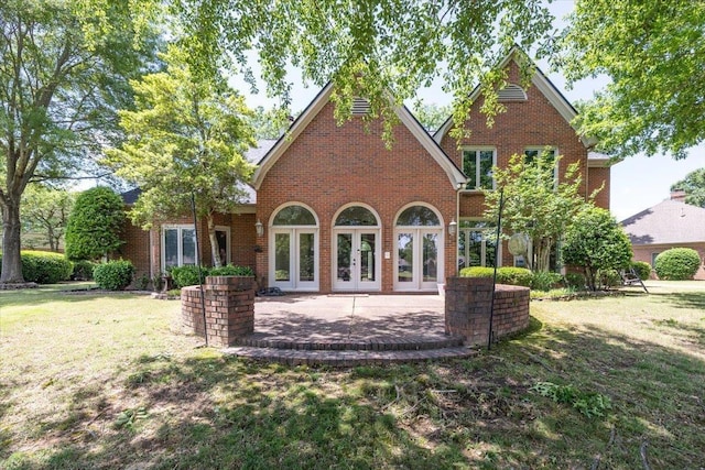 10336 Hatcher Patch Cv, Collierville, TN 38017 - back of property featuring french doors, a lawn, and brick siding
