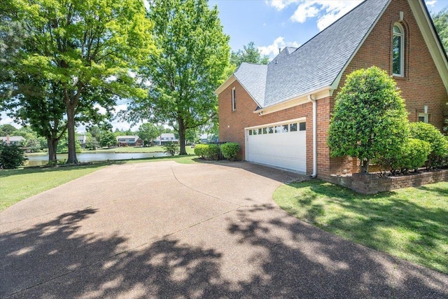 10336 Hatcher Patch Cv, Collierville, TN 38017 - view of property exterior featuring a shingled roof, driveway, brick siding, a water view, and a lawn