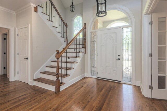10336 Hatcher Patch Cv, Collierville, TN 38017 - entrance foyer with dark wood-style flooring, stairway, baseboards, and ornamental molding