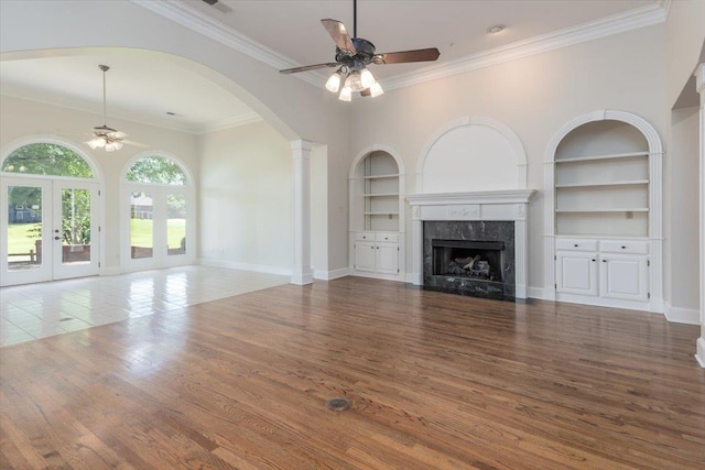 10336 Hatcher Patch Cv, Collierville, TN 38017 - unfurnished living room with ceiling fan, built in shelves, a fireplace, crown molding, and french doors