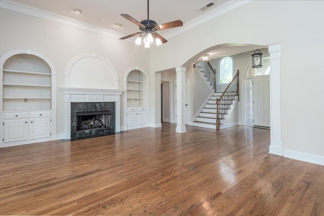 10336 Hatcher Patch Cv, Collierville, TN 38017 - unfurnished living room with built in features, ceiling fan, ornamental molding, a premium fireplace, and baseboards