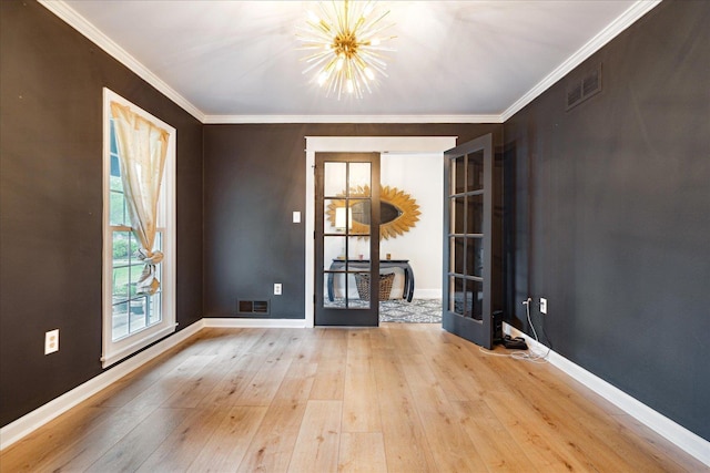 1366 Kirby Rd, Memphis, TN 38120 - spare room featuring a chandelier, hardwood / wood-style floors, baseboards, crown molding, and french doors