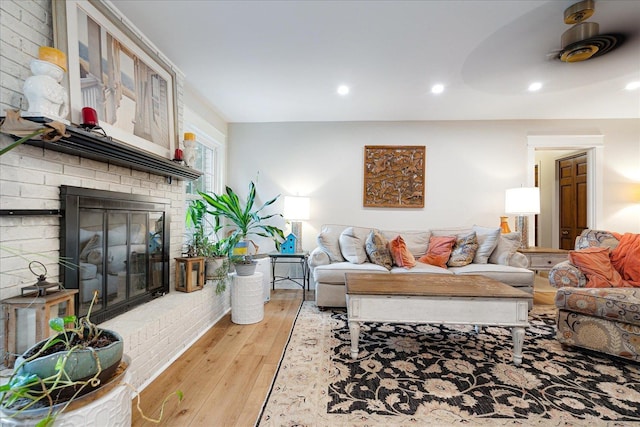1366 Kirby Rd, Memphis, TN 38120 - living room featuring light wood-style floors, a brick fireplace, and recessed lighting