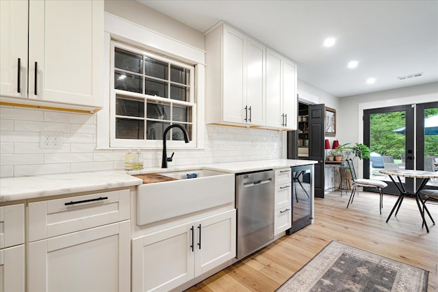 1366 Kirby Rd, Memphis, TN 38120 - kitchen featuring stainless steel dishwasher, beverage cooler, a sink, tasteful backsplash, and light wood finished floors