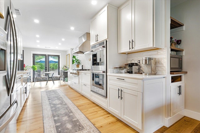 1366 Kirby Rd, Memphis, TN 38120 - kitchen with stainless steel appliances, wall chimney exhaust hood, open shelves, tasteful backsplash, and recessed lighting