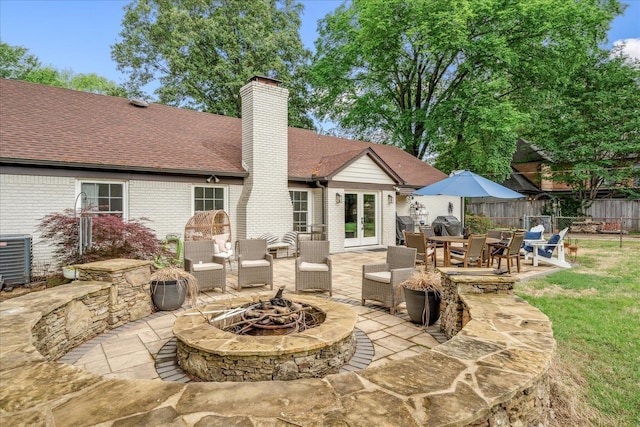 1366 Kirby Rd, Memphis, TN 38120 - back of property with an outdoor fire pit, french doors, a chimney, and brick siding