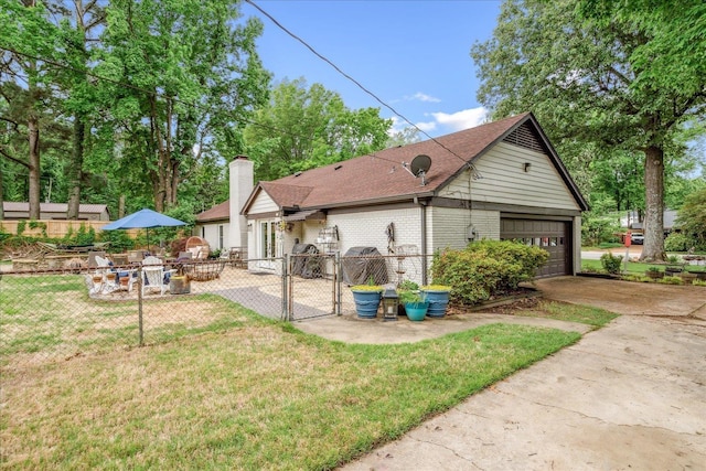 1366 Kirby Rd, Memphis, TN 38120 - view of side of home featuring a gate, a garage, a chimney, brick siding, and a shingled roof