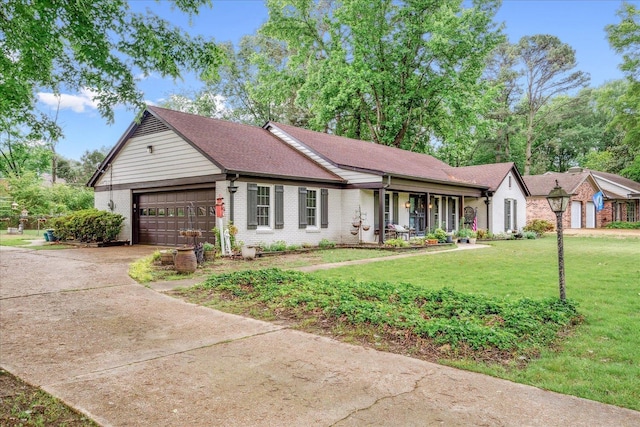 1366 Kirby Rd, Memphis, TN 38120 - ranch-style home with a garage, concrete driveway, a porch, a front lawn, and brick siding