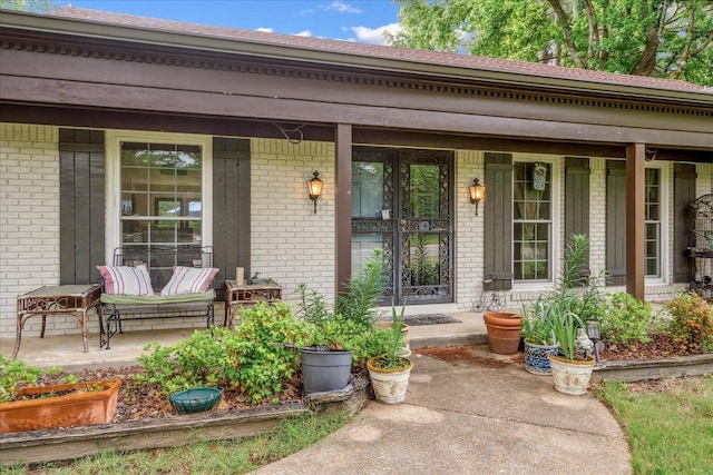 1366 Kirby Rd, Memphis, TN 38120 - doorway to property featuring a porch and brick siding