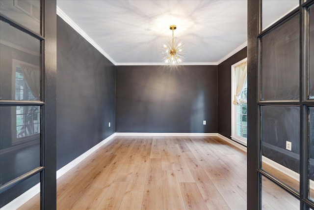 1366 Kirby Rd, Memphis, TN 38120 - unfurnished dining area with a chandelier, crown molding, light wood-type flooring, and baseboards