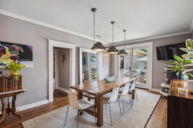 dining space with french doors, baseboards, wood finished floors, and crown molding