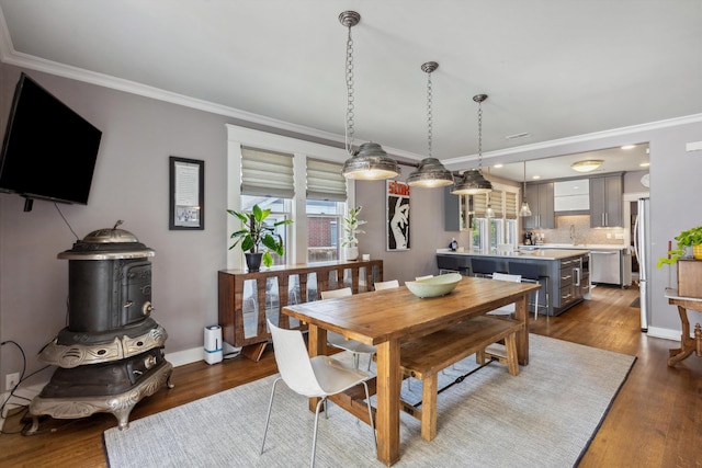 dining space with ornamental molding, dark wood-type flooring, and baseboards